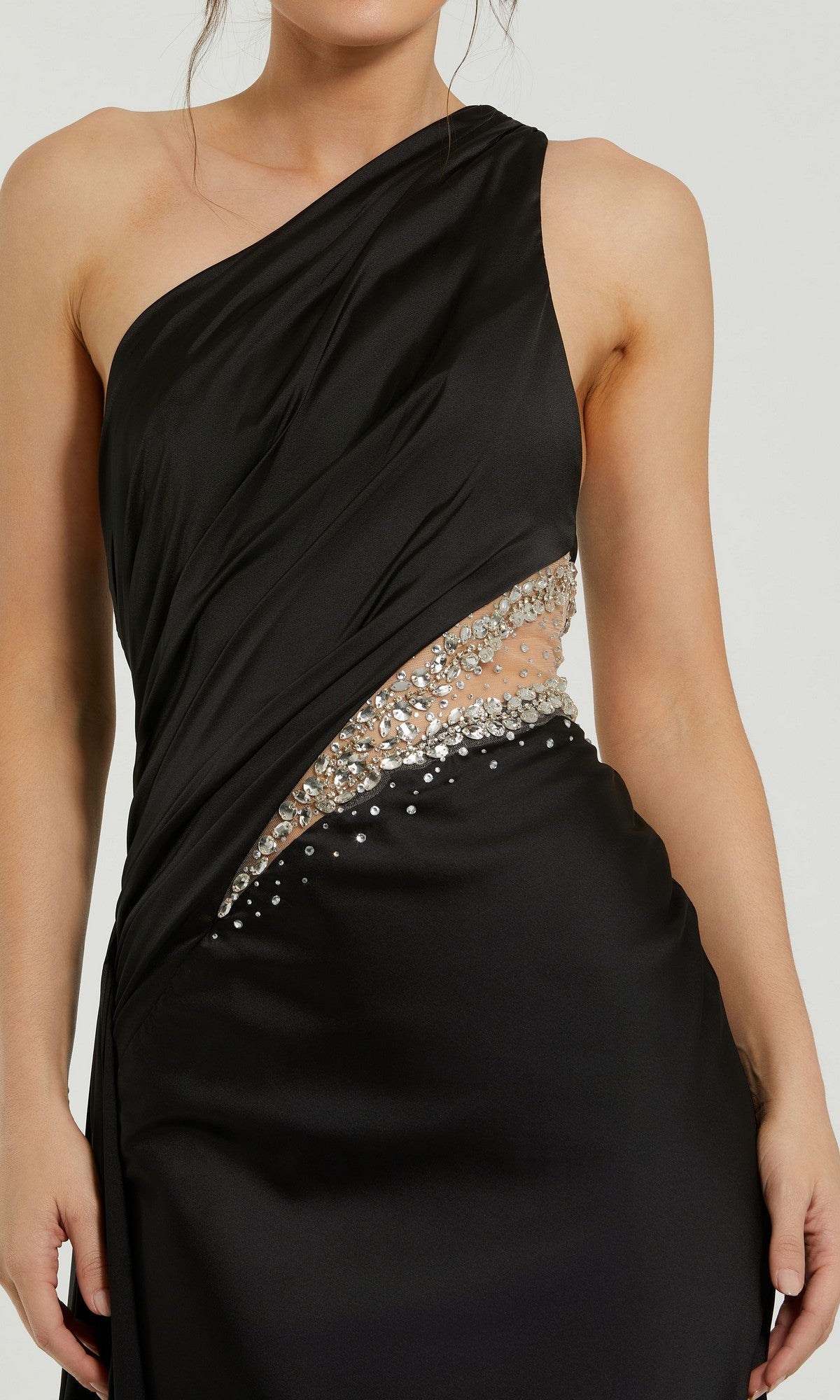 A woman wears the Mac Duggal 2210 Cut-Out One-Shoulder Formal Dress featuring a diagonal rhinestone-adorned waist cutout.